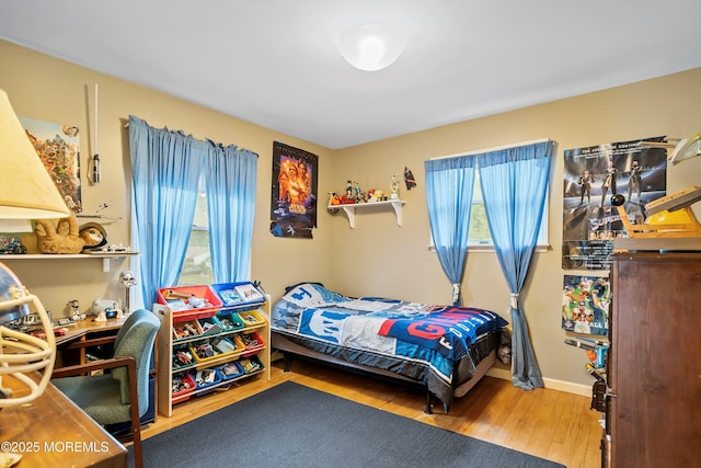 bedroom with wood finished floors and baseboards