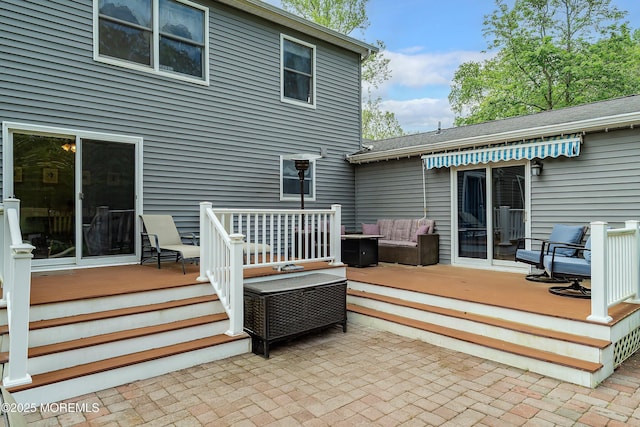 rear view of house featuring a deck and outdoor lounge area