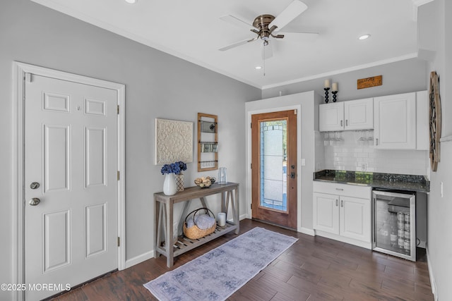 18 Franklin Pkwy, West Long Branch, NJ 07764 - entrance foyer with wine cooler, ceiling fan, crown molding, dark wood-style flooring, and baseboards