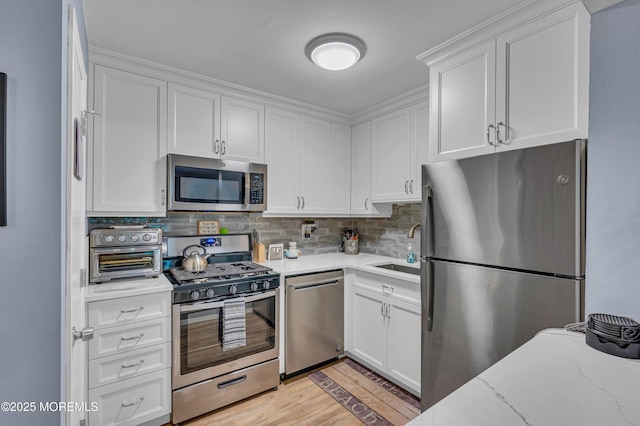 3403 Bridge Ave Unit 2, Point Pleasant, NJ 08742 - kitchen with appliances with stainless steel finishes, white cabinets, and a sink