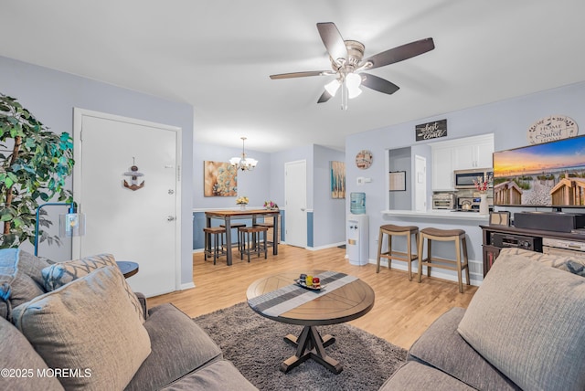 3403 Bridge Ave Unit 2, Point Pleasant, NJ 08742 - living area featuring a chandelier, a ceiling fan, light wood finished floors, and baseboards