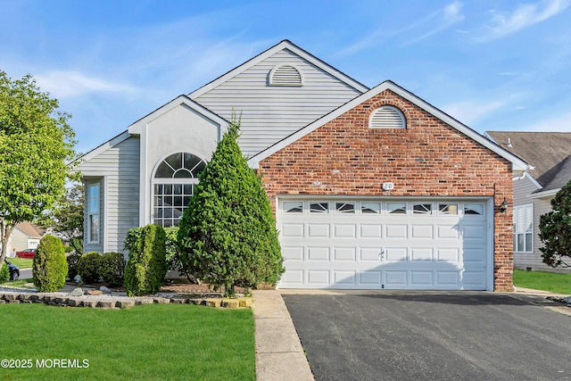 20 Abergele Dr, Toms River, NJ 08757 - view of front facade with brick siding, driveway, a garage, and a front lawn
