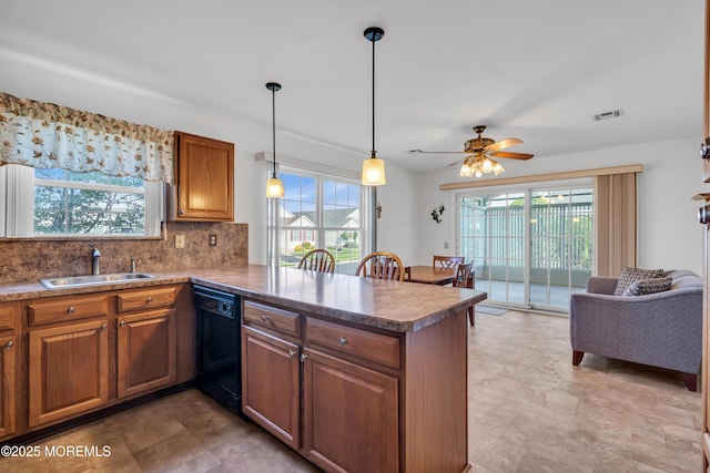 20 Abergele Dr, Toms River, NJ 08757 - kitchen with a sink, black dishwasher, a peninsula, backsplash, and brown cabinets