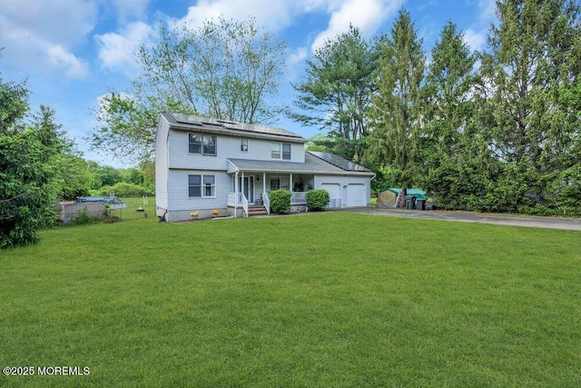 view of front of home with asphalt driveway, a garage, and solar panels