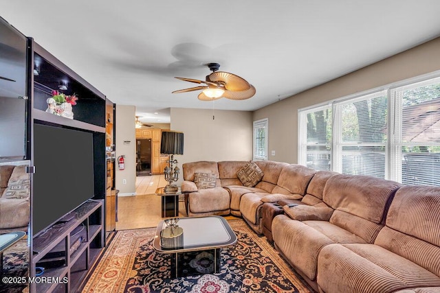 living room with a ceiling fan and light wood-style floors