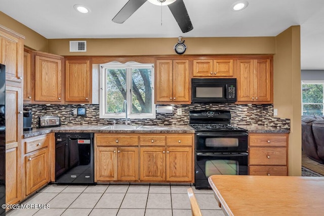 kitchen featuring black appliances, a sink, tasteful backsplash, light tile patterned floors, and recessed lighting