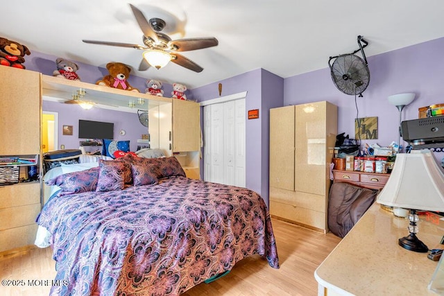 bedroom with light wood finished floors, a closet, and ceiling fan