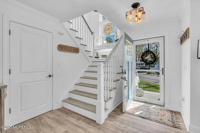 74 Dock Rd, Brick, NJ 08723 - foyer entrance with stairs, ornamental molding, a chandelier, light wood finished floors, and baseboards