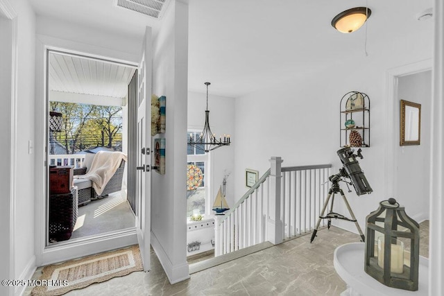 74 Dock Rd, Brick, NJ 08723 - hall featuring a chandelier, marble finish floors, an upstairs landing, and baseboards
