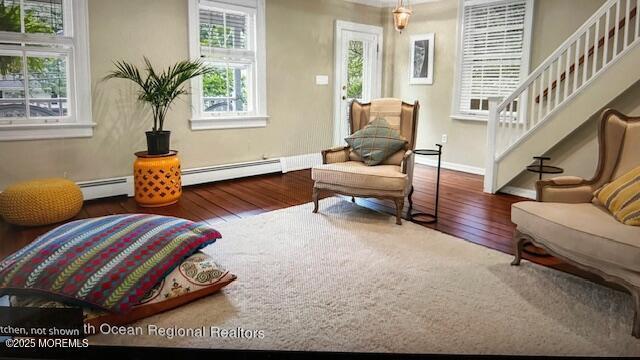 46 Grand Tour, Highlands, NJ 07732 - sitting room with wood finished floors, stairway, baseboards, and baseboard heating