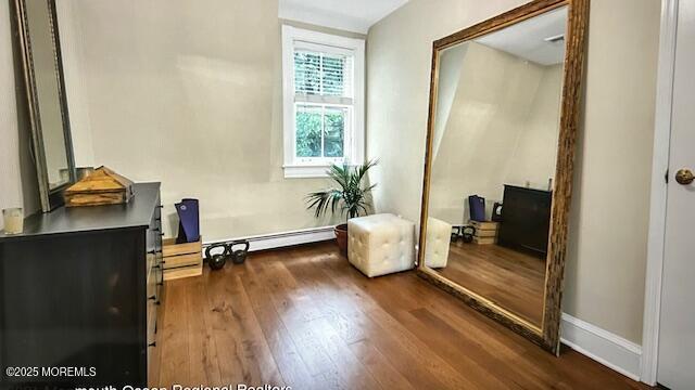 46 Grand Tour, Highlands, NJ 07732 - bedroom featuring a baseboard radiator, dark wood-type flooring, baseboards, and an office area