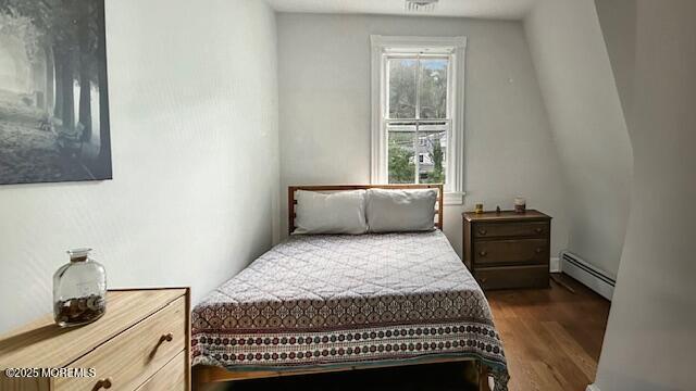46 Grand Tour, Highlands, NJ 07732 - bedroom featuring a baseboard heating unit and dark wood-style flooring
