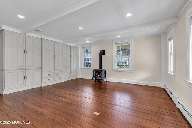 46 Grand Tour, Highlands, NJ 07732 - unfurnished living room featuring a wood stove, wood-type flooring, beam ceiling, a baseboard radiator, and baseboards