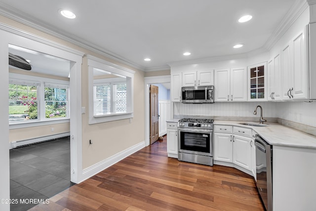 46 Grand Tour, Highlands, NJ 07732 - kitchen featuring appliances with stainless steel finishes, baseboard heating, a sink, white cabinets, and crown molding
