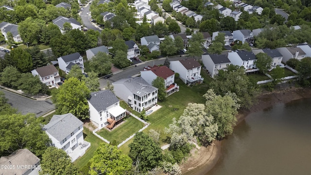 aerial overview of property's location with nearby suburban area and a nearby body of water