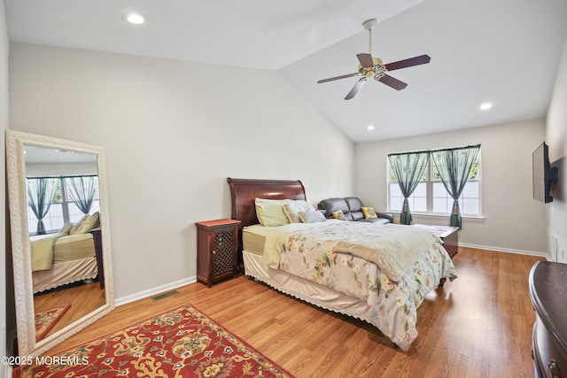 bedroom with multiple windows, wood finished floors, baseboards, high vaulted ceiling, and recessed lighting