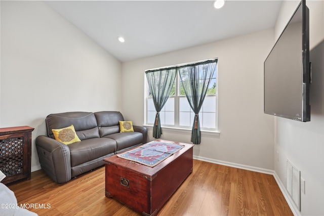 living room featuring light wood finished floors, recessed lighting, and baseboards