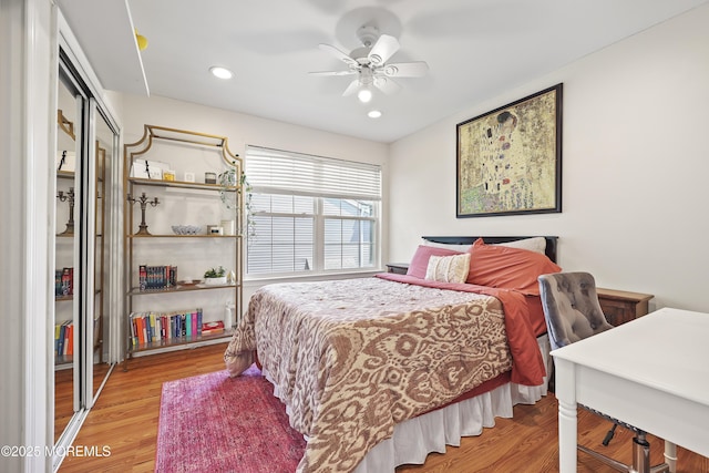 bedroom with wood finished floors, a closet, a ceiling fan, and recessed lighting