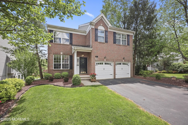 view of front of property with driveway, brick siding, an attached garage, and a front yard