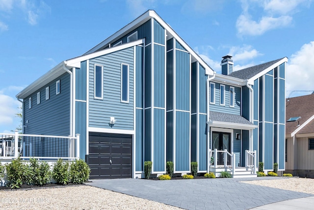 3 Toledo Dr, Brick, NJ 08723 - contemporary house featuring driveway, a chimney, and a garage