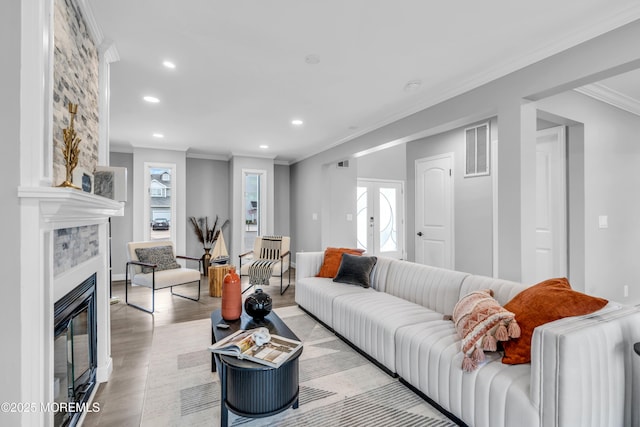 3 Toledo Dr, Brick, NJ 08723 - living area with ornamental molding, recessed lighting, a glass covered fireplace, and light wood finished floors