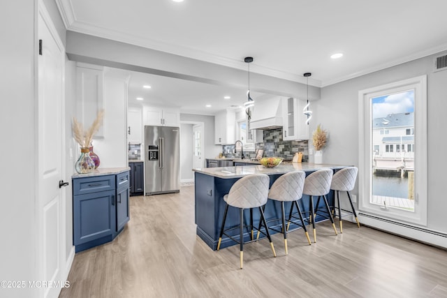3 Toledo Dr, Brick, NJ 08723 - kitchen with high end fridge, a peninsula, custom range hood, light wood-style flooring, and a breakfast bar