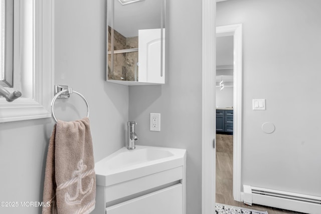 3 Toledo Dr, Brick, NJ 08723 - full bathroom featuring a baseboard heating unit, vanity, tiled shower, and wood finished floors