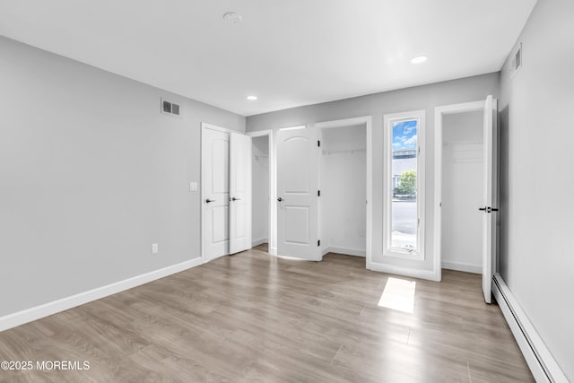 3 Toledo Dr, Brick, NJ 08723 - unfurnished bedroom with baseboard heating, multiple closets, recessed lighting, and light wood-type flooring