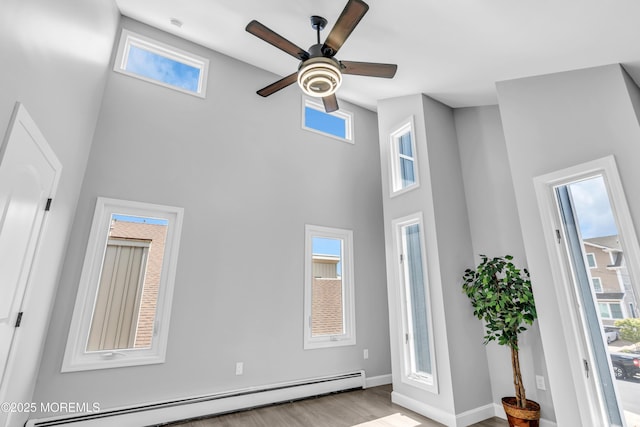 3 Toledo Dr, Brick, NJ 08723 - interior space with baseboard heating, a high ceiling, wood finished floors, and ceiling fan