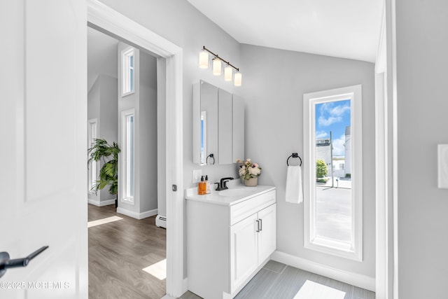 3 Toledo Dr, Brick, NJ 08723 - bathroom with vanity, lofted ceiling, wood finished floors, and baseboard heating