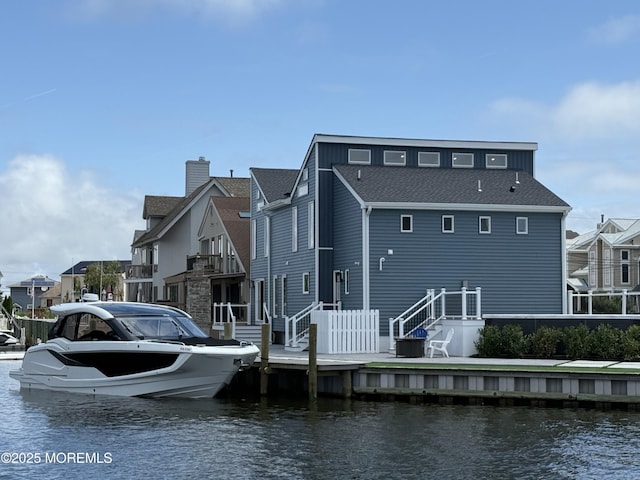 3 Toledo Dr, Brick, NJ 08723 - rear view of house with a water view, a shingled roof, and a chimney