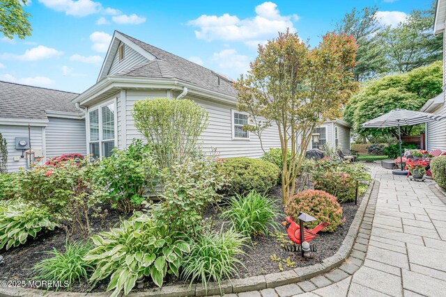 178 Loganberry Ln, Freehold, NJ 07728 - view of side of property with a shingled roof and a patio area