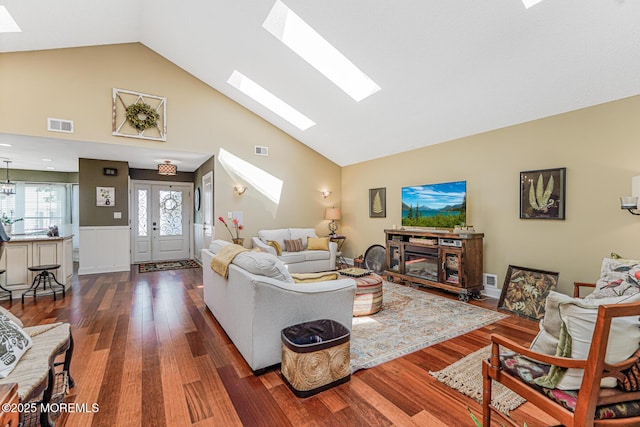 178 Loganberry Ln, Freehold, NJ 07728 - living area with a skylight, wood finished floors, high vaulted ceiling, and a wainscoted wall