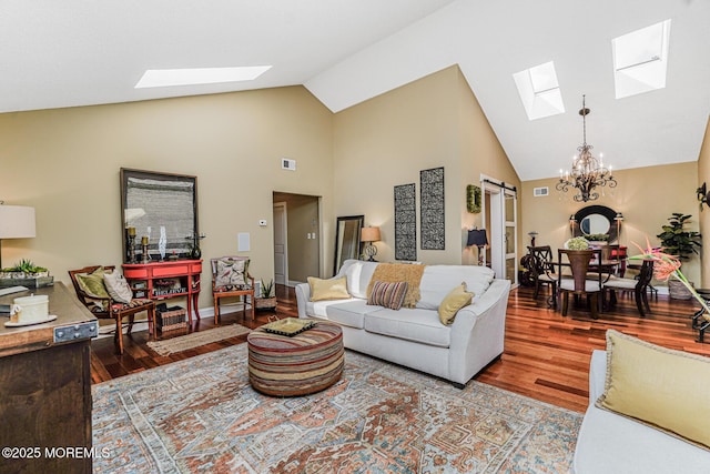 178 Loganberry Ln, Freehold, NJ 07728 - living room featuring a skylight, wood finished floors, high vaulted ceiling, and a chandelier