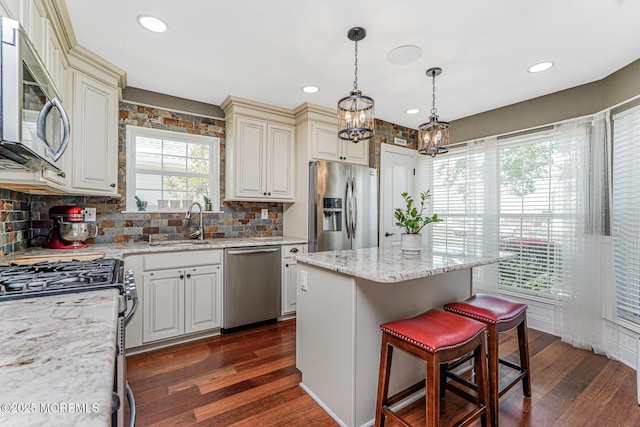 178 Loganberry Ln, Freehold, NJ 07728 - kitchen with stainless steel appliances, a sink, dark wood-style floors, a chandelier, and decorative backsplash