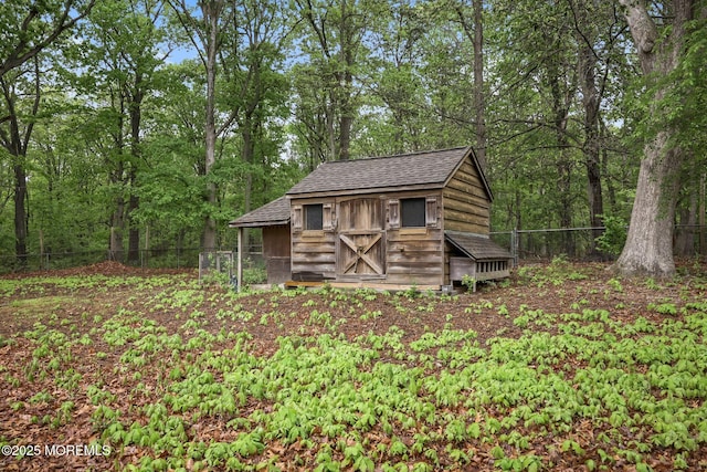 view of shed featuring fence