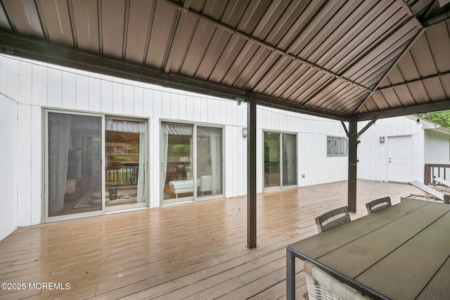 wooden deck with outdoor dining space and a gazebo