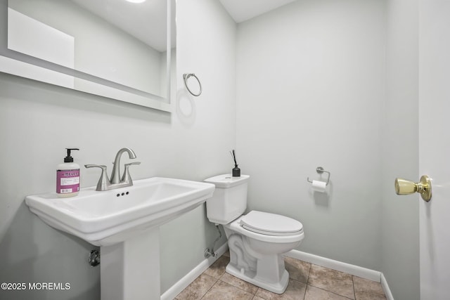 bathroom featuring baseboards, toilet, and tile patterned flooring