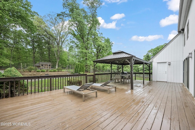 deck featuring a gazebo and outdoor dining area