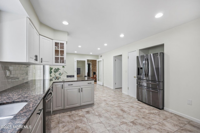 kitchen with stainless steel fridge with ice dispenser, dishwasher, white cabinetry, decorative backsplash, and glass insert cabinets