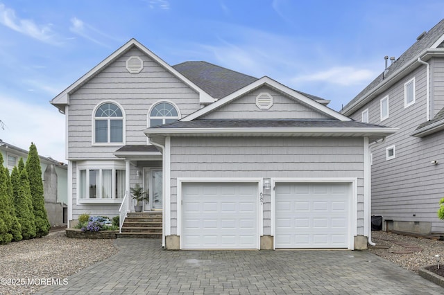 687 Princeton Ave, Brick, NJ 08724 - view of front facade with decorative driveway, a garage, and roof with shingles