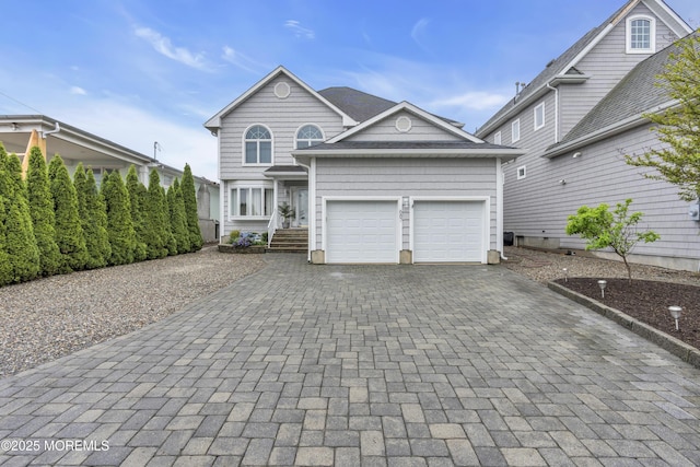 687 Princeton Ave, Brick, NJ 08724 - traditional home featuring decorative driveway and an attached garage