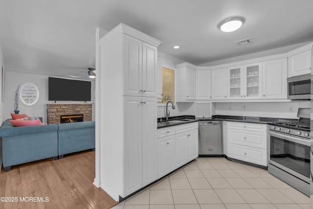 687 Princeton Ave, Brick, NJ 08724 - kitchen with stainless steel appliances, a sink, open floor plan, ceiling fan, and white cabinetry