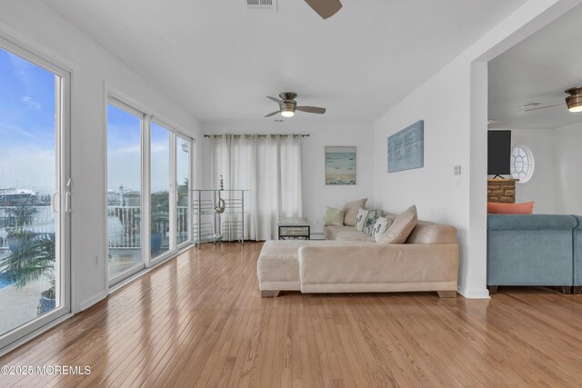 687 Princeton Ave, Brick, NJ 08724 - living room with ceiling fan, light wood-style flooring, and baseboards