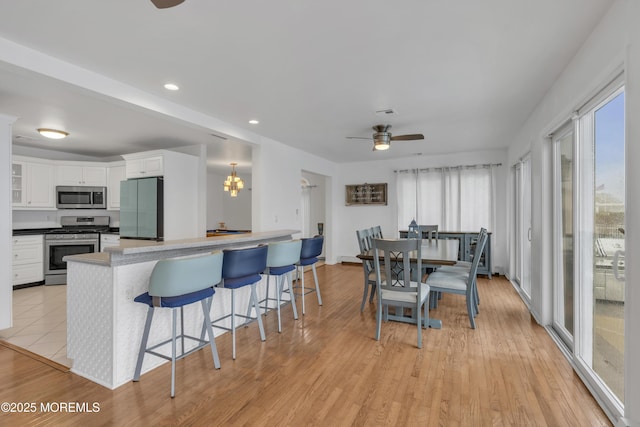 687 Princeton Ave, Brick, NJ 08724 - kitchen featuring appliances with stainless steel finishes, a ceiling fan, white cabinetry, a breakfast bar, and a peninsula