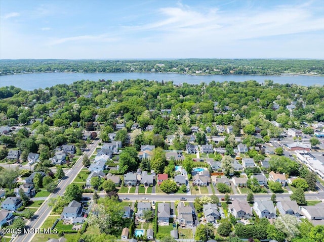 aerial perspective of suburban area featuring a nearby body of water