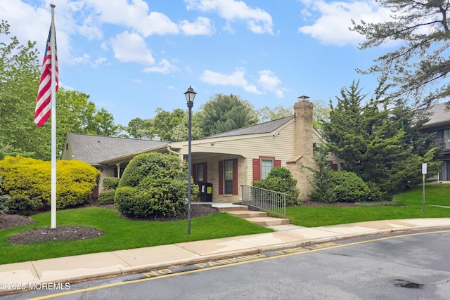 293 Gloucester Ct, Matawan, NJ 07747 - view of front of home featuring a chimney, a front yard, and brick siding
