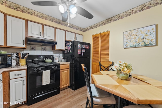293 Gloucester Ct, Matawan, NJ 07747 - kitchen with black appliances, under cabinet range hood, light countertops, light wood-type flooring, and ceiling fan
