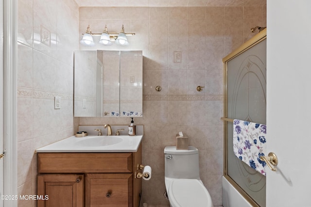 293 Gloucester Ct, Matawan, NJ 07747 - bathroom featuring tile walls, vanity, bath / shower combo with glass door, and toilet