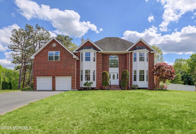 1041 Aumack Rd, Jackson, NJ 08527 - georgian-style home with asphalt driveway, a garage, brick siding, and a chimney